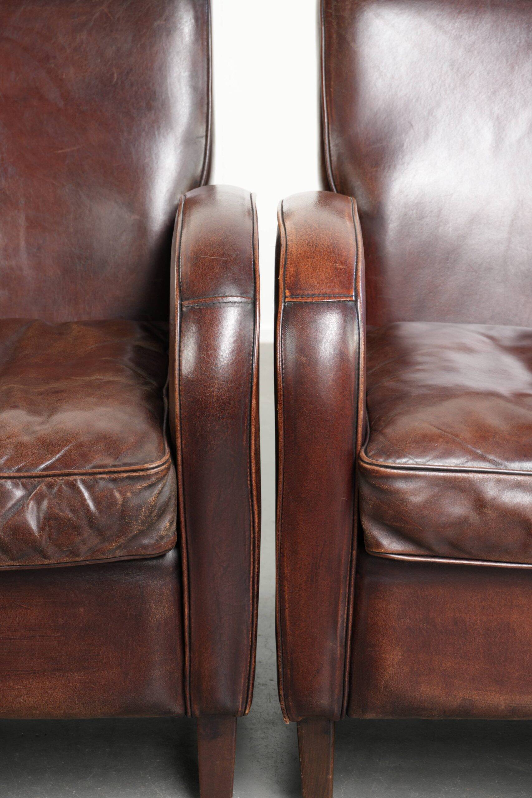 Dark cognac-coloured set of 2 sheepskin armchairs with a sleek design
