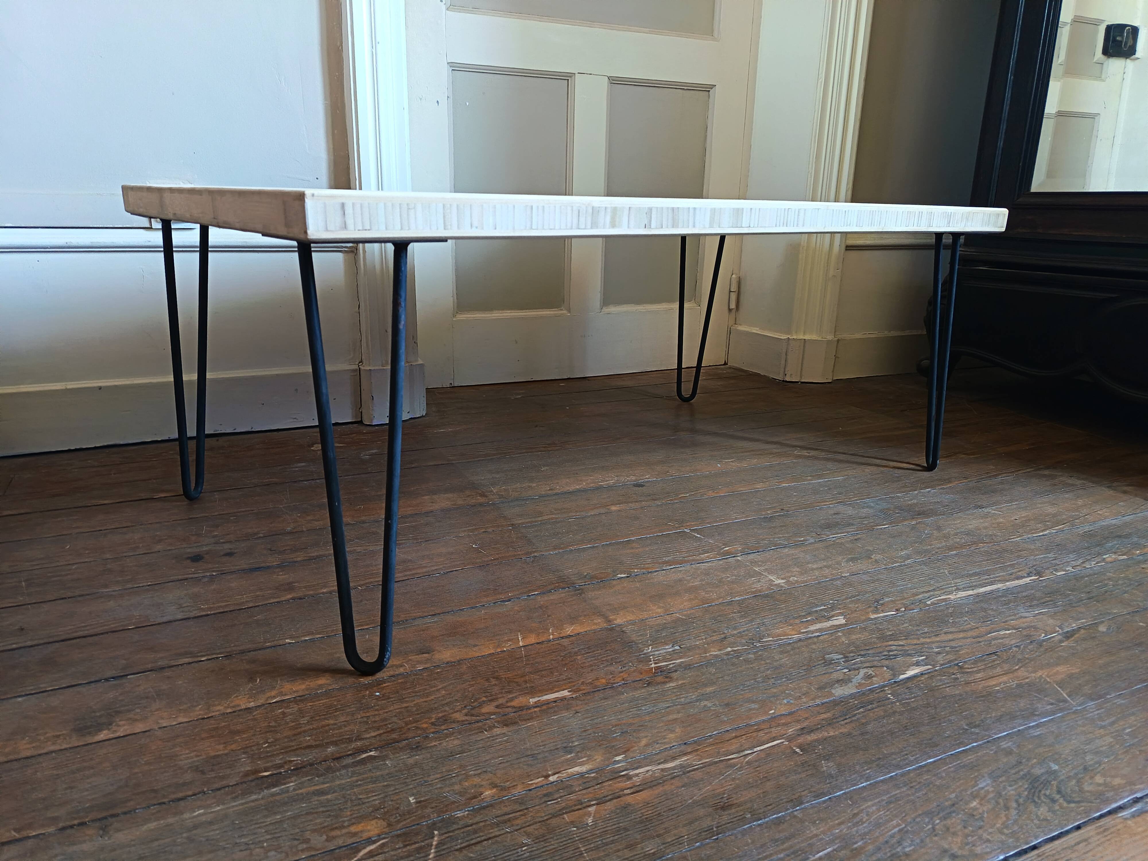 Coffee table in solid bamboo with steel legs.