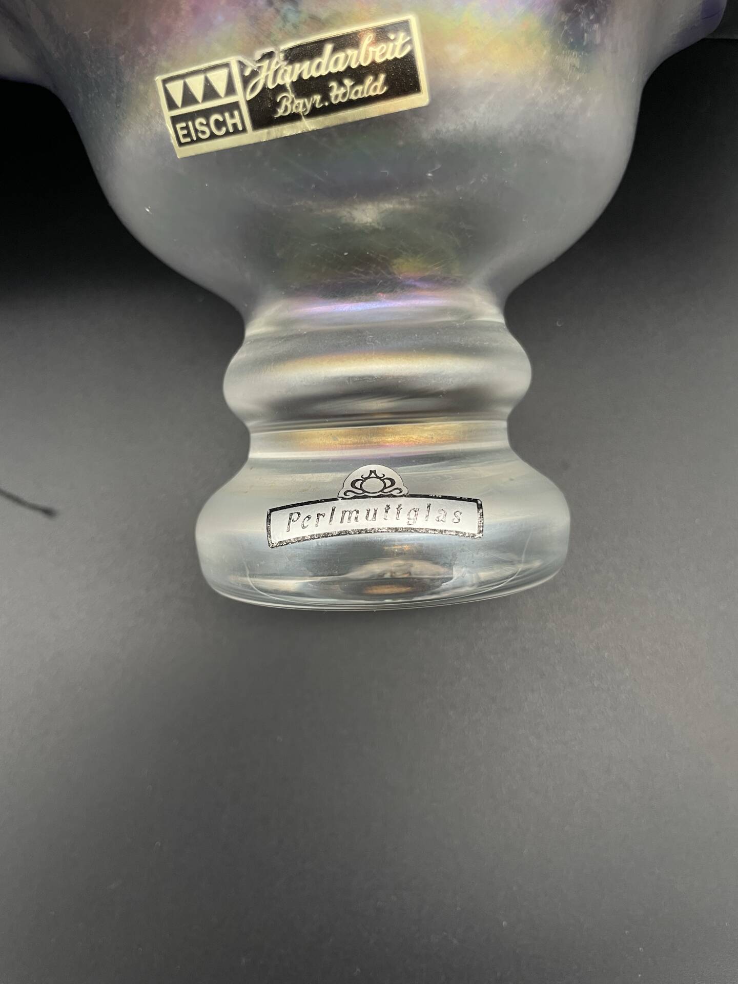 Eisch glass footed cup with pearlescent finish, blue rim.