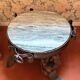 Wrought iron and hammered marble coffee table circa 1950.