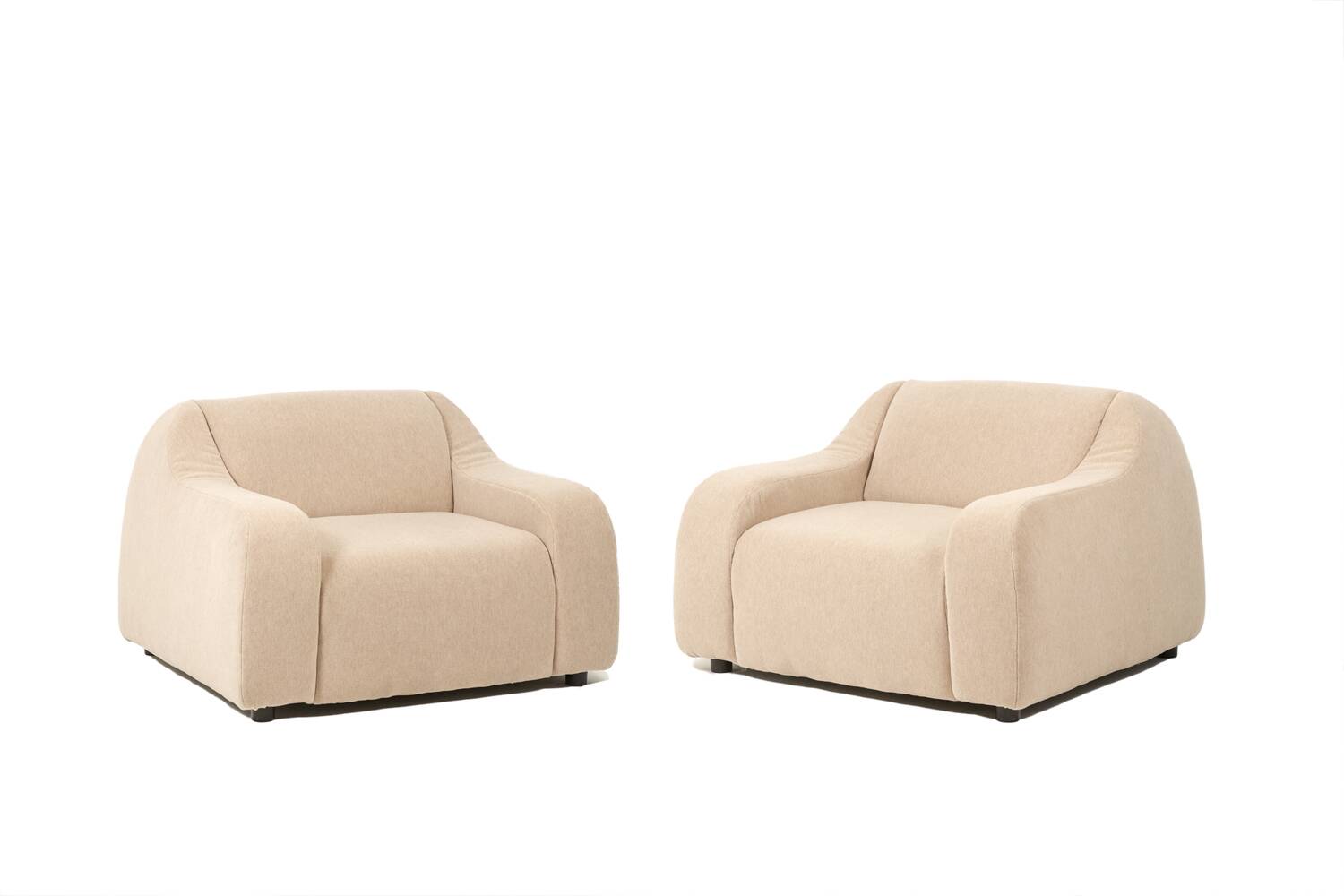 A pair of large and comfortable beige fabric armchairs. Contemporary.