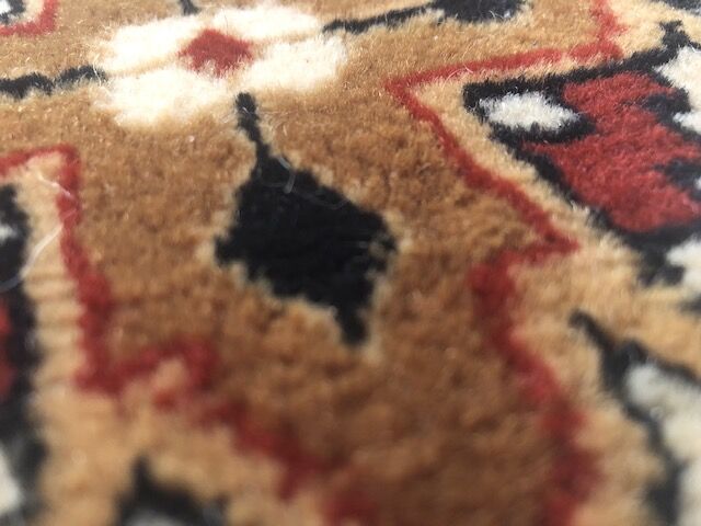 Wool carpet with oriental decoration on a brown background