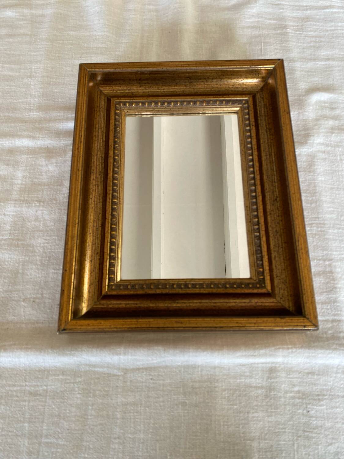 Bronze-colored framed mirror