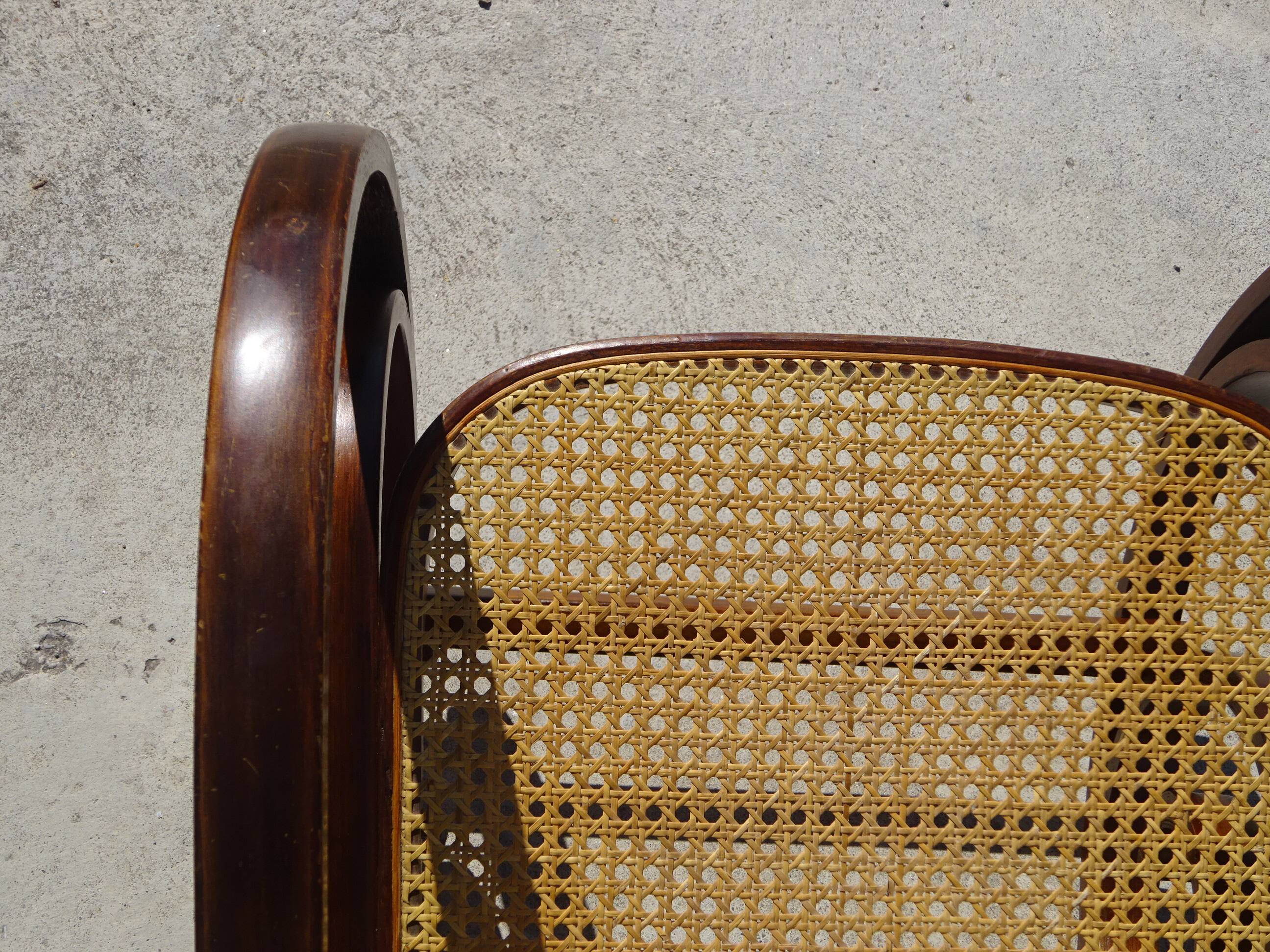 Vintage wooden rocking chair with caning