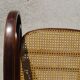 Vintage wooden rocking chair with caning