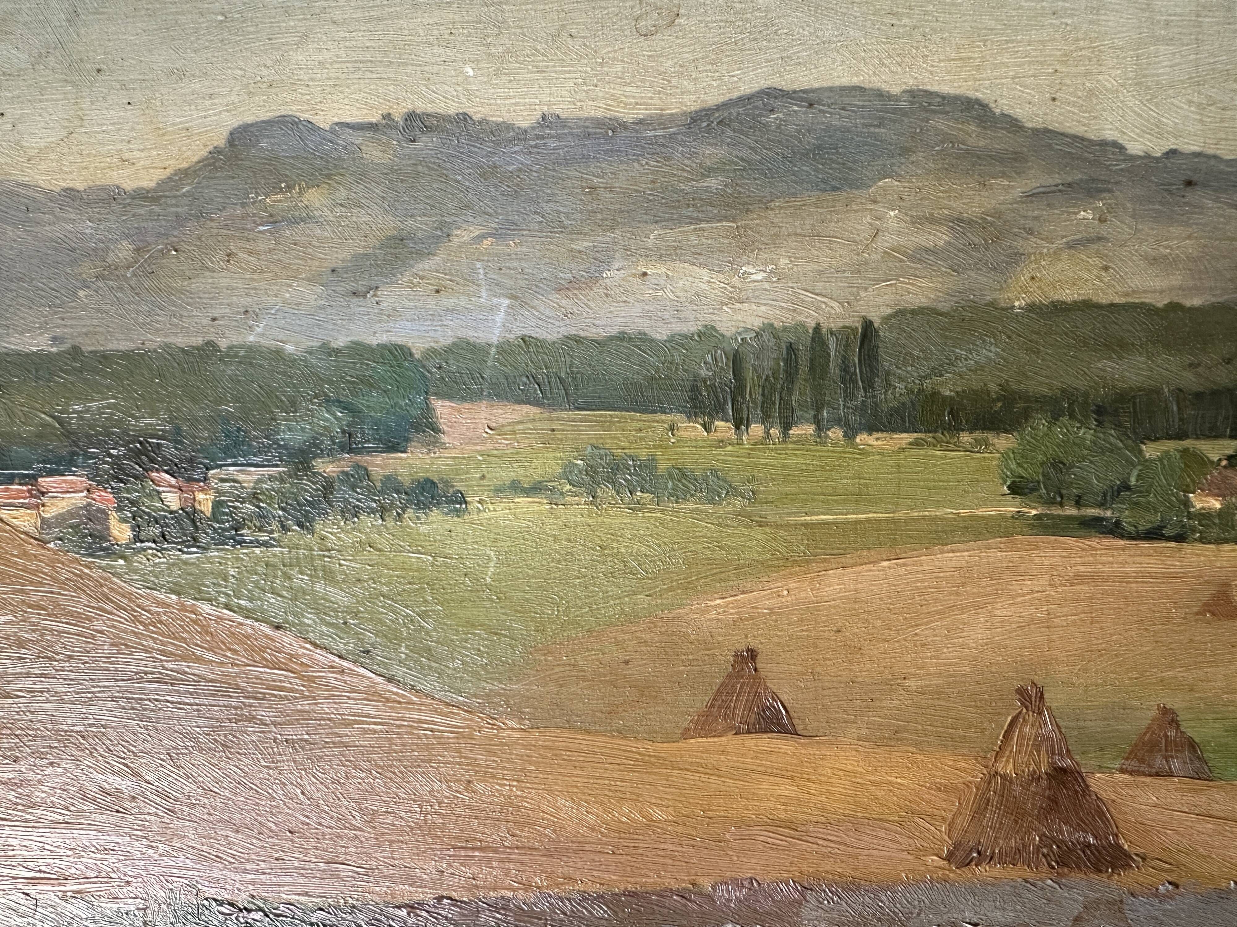Old oil painting of a landscape on panel from 1920, haystacks.