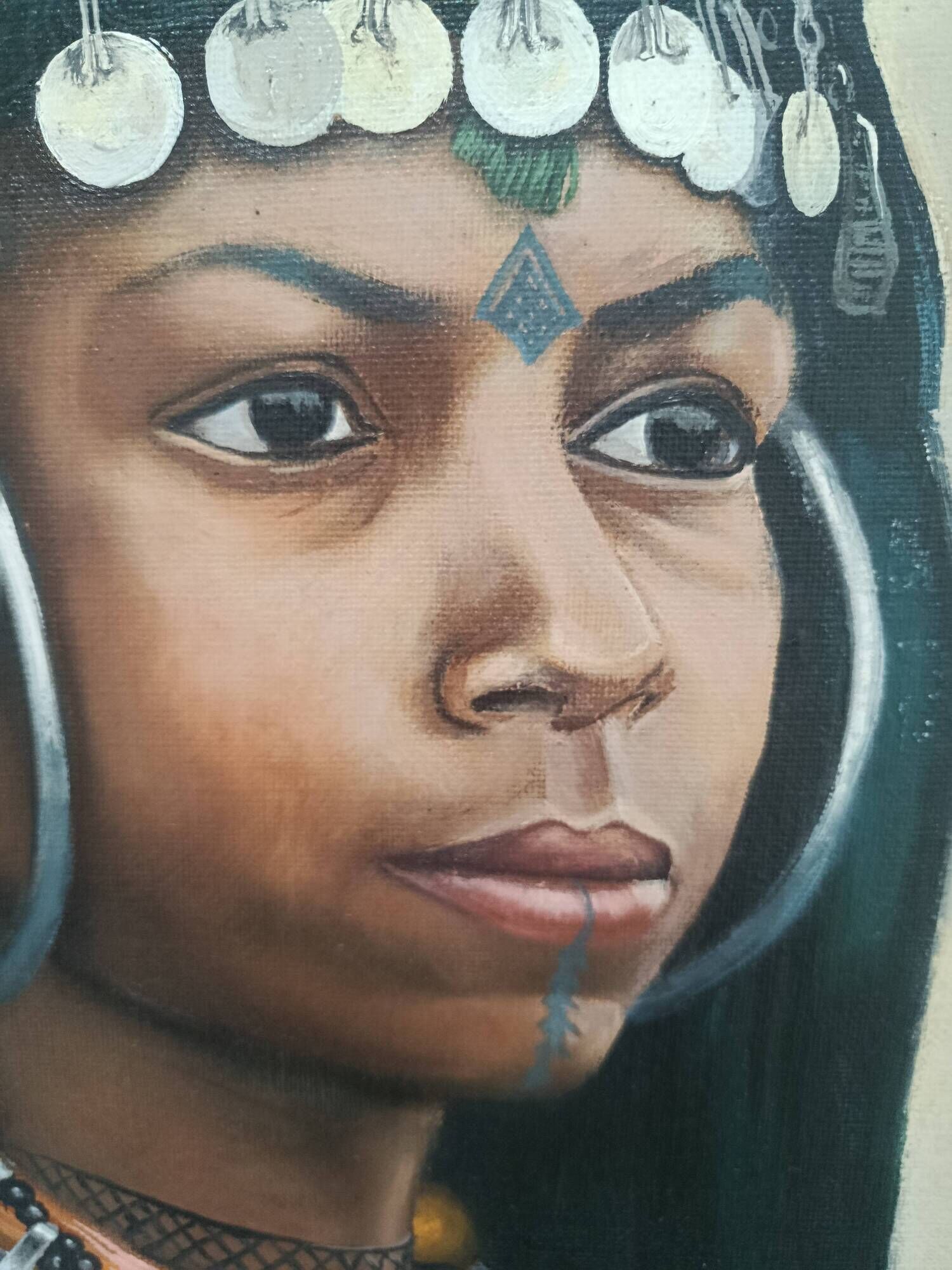 Portrait of a young Moroccan woman in traditional attire and adornments.