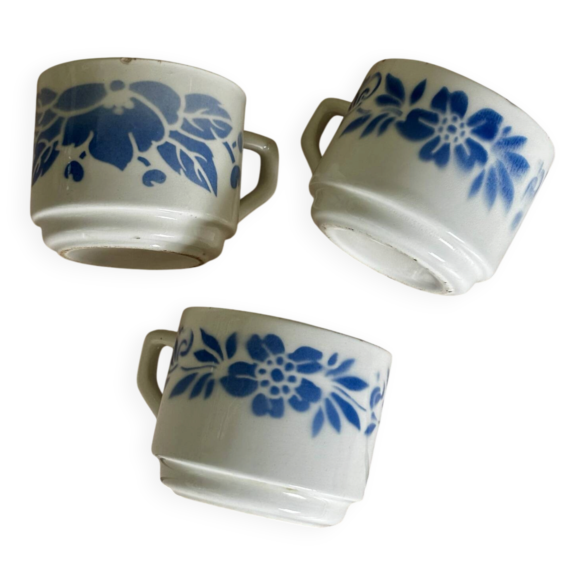 Set of 3 antique ceramic cups with blue floral pattern.
