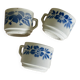 Set of 3 antique ceramic cups with blue floral pattern.