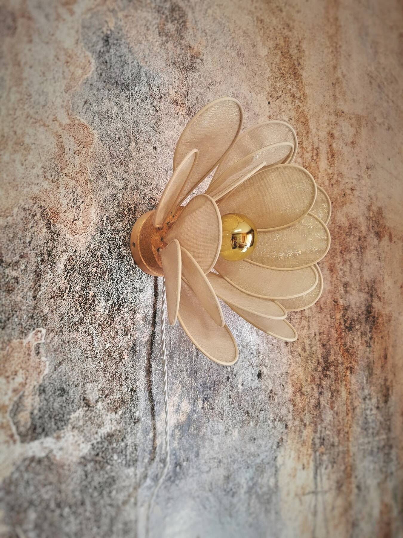 Flower wall light made of rattan petals and gold fabric