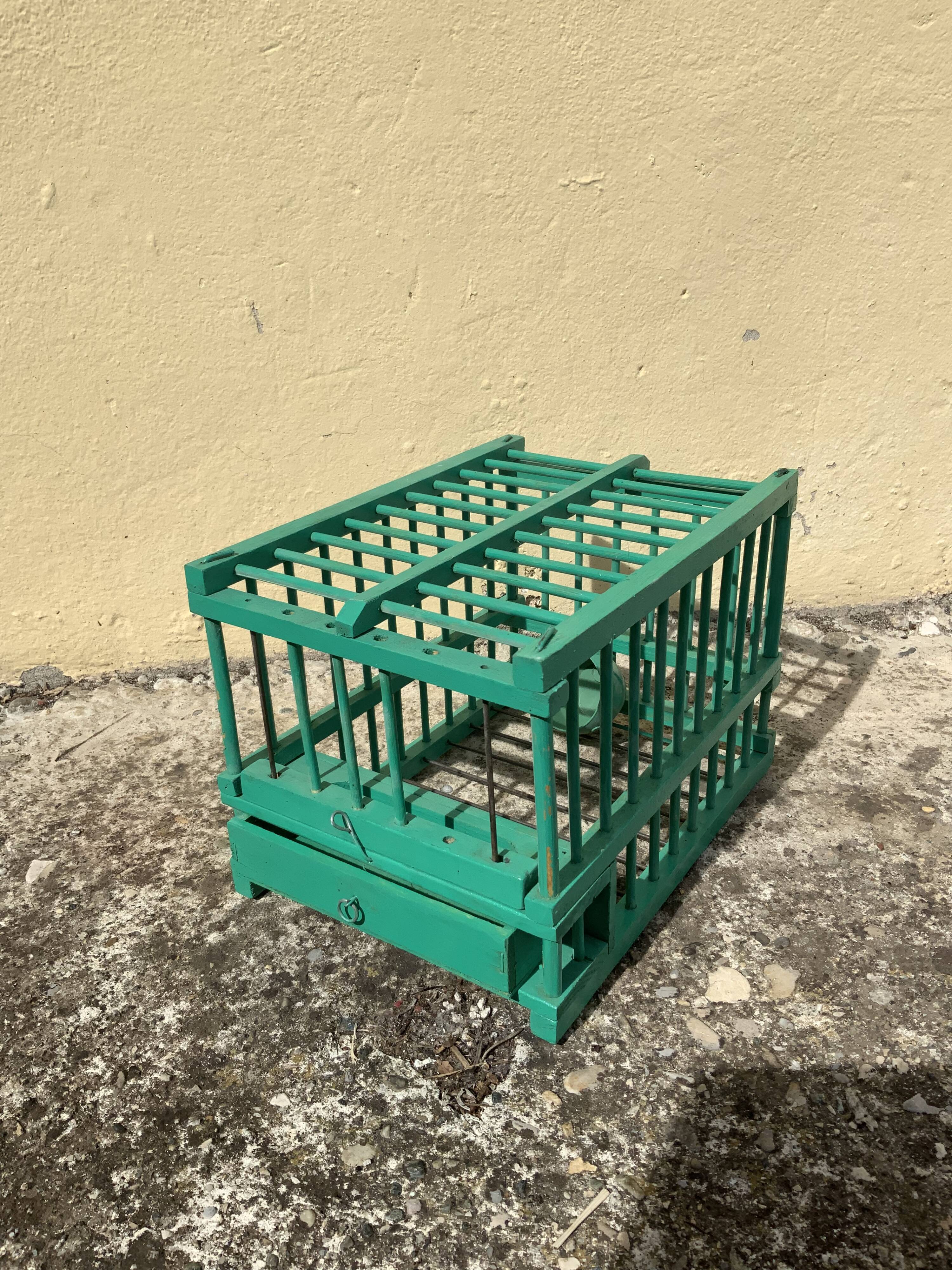 Vintage bird cage in green wood retro paint