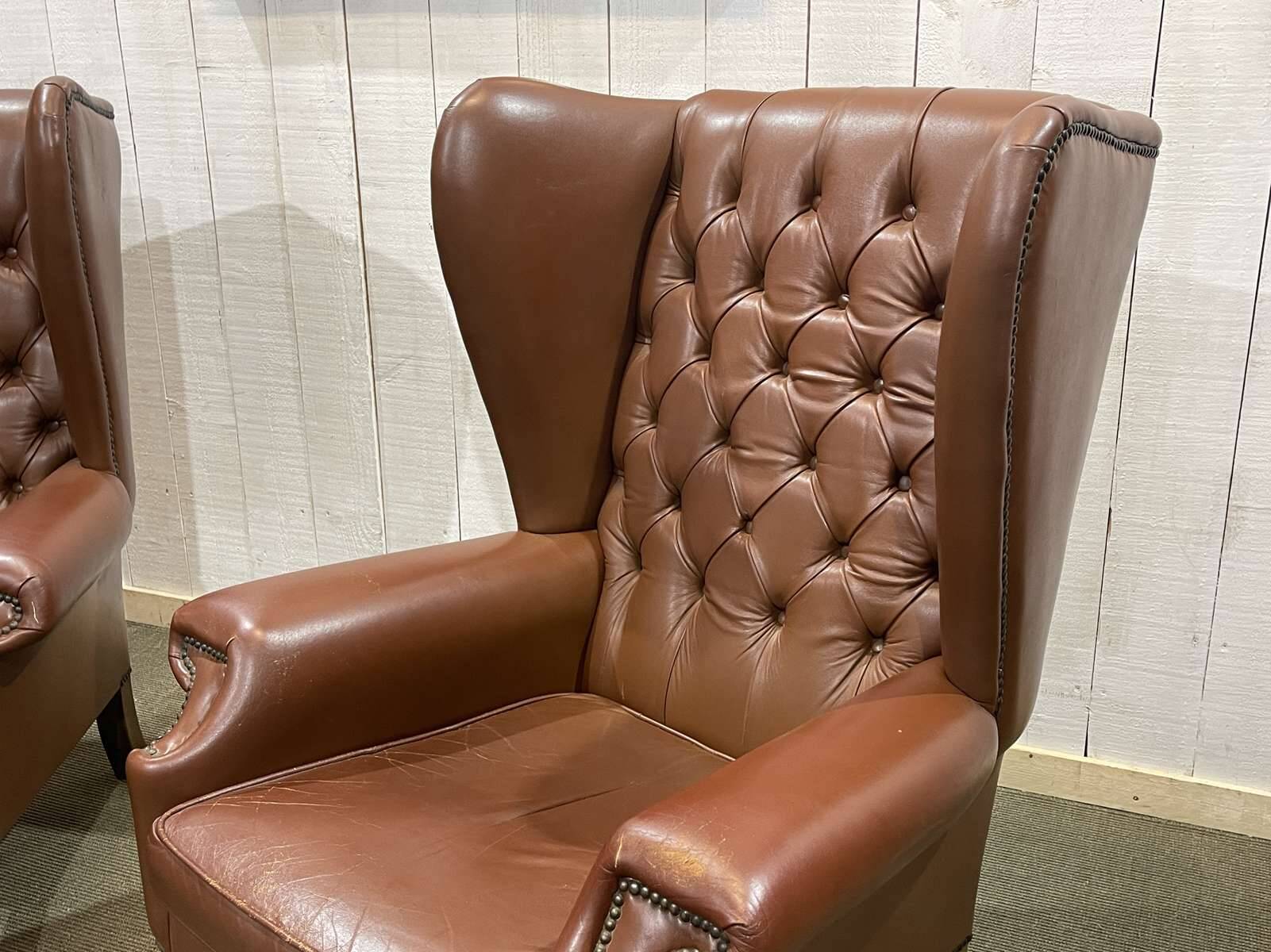 Pair of brown leather wingback Chesterfield armchairs from the 1970s.