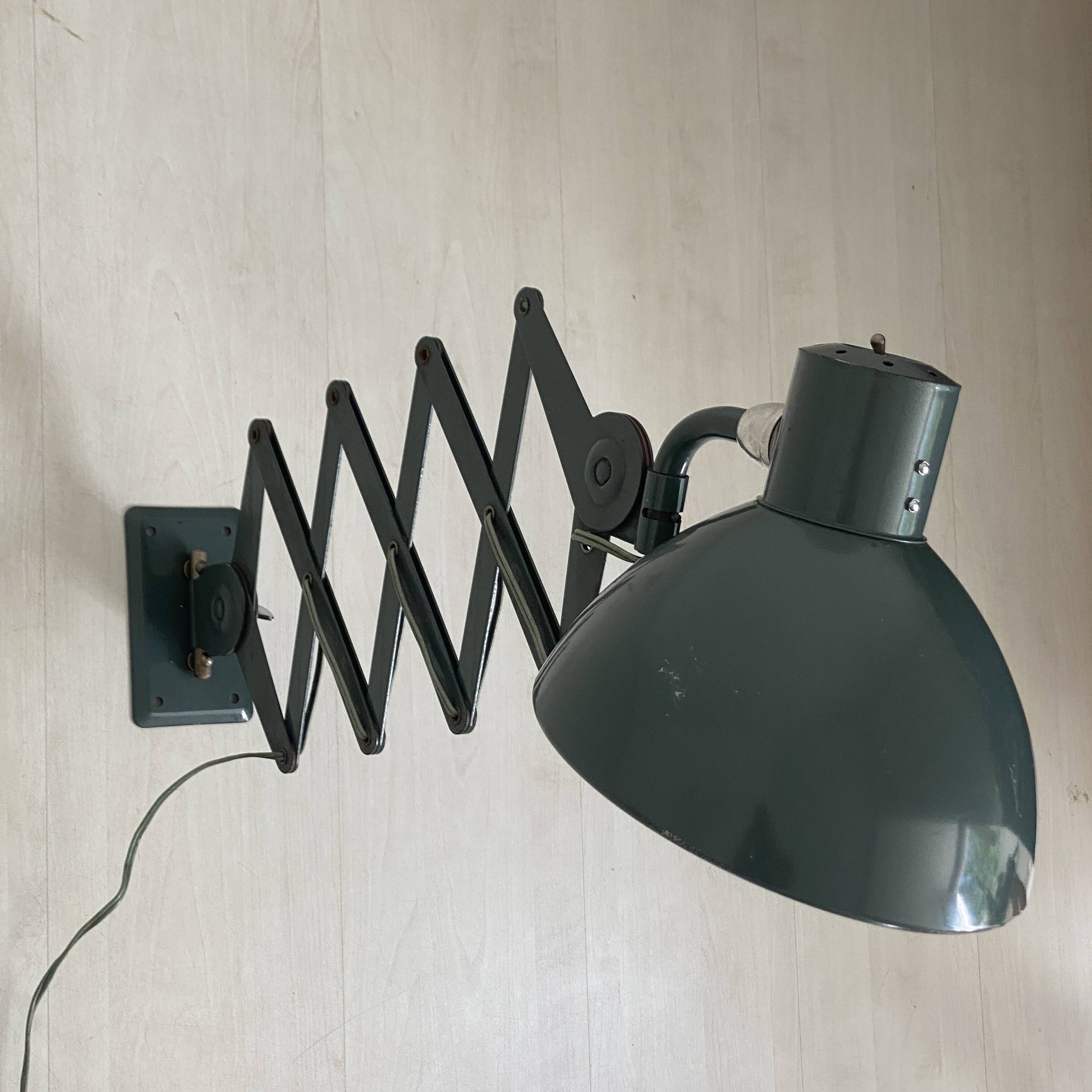 Vintage 1950s green lacquered sheet metal workshop wall light with accordion arm.