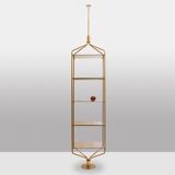 Free-standing shelf in gilded brass with smoked glass shelves. 1970s.