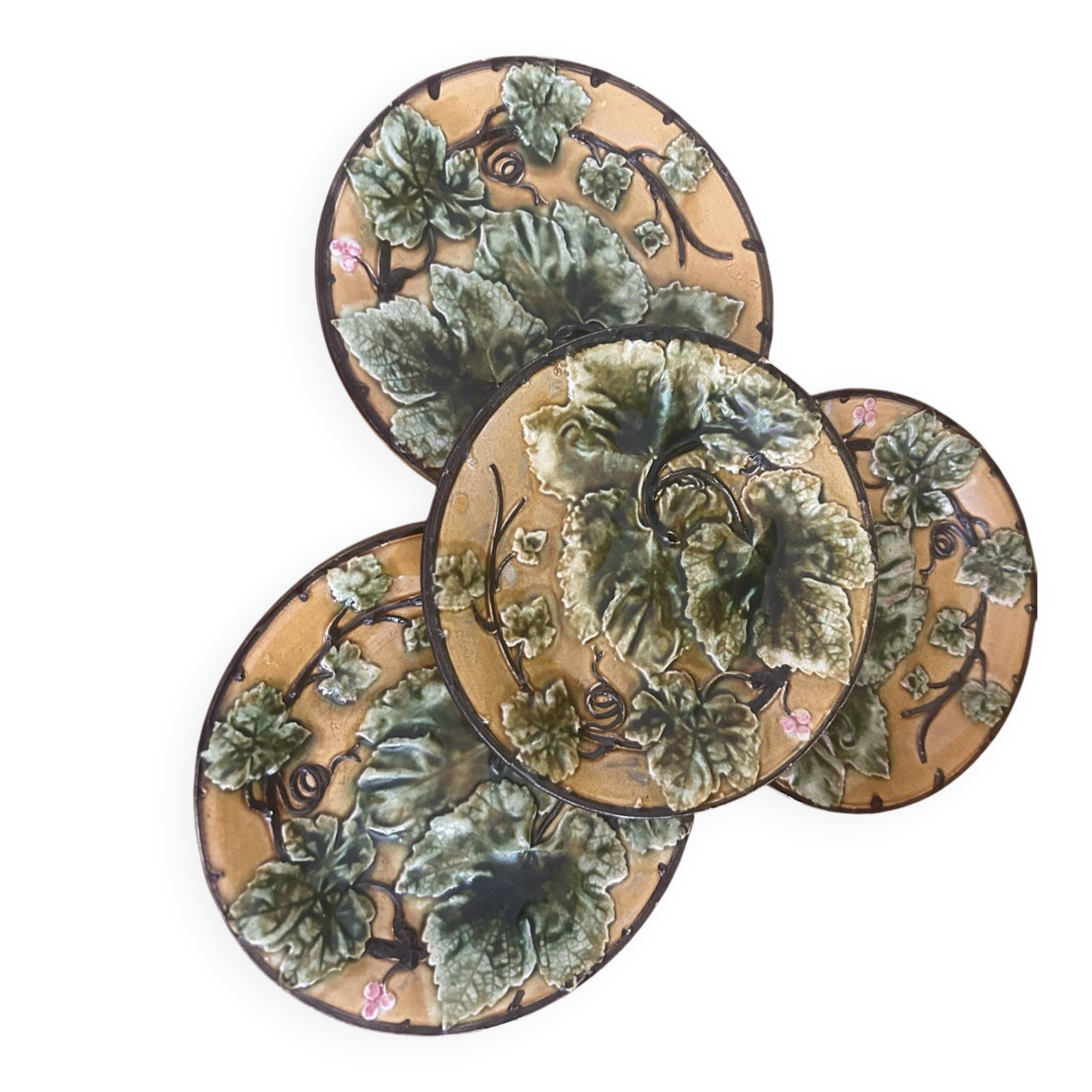 Four antique dessert plates in majolica with vine decoration.