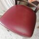 Set of 19 vintage wooden bistro chairs with red faux leather.
