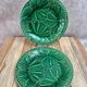Set of 2 green earthenware dessert plates with vine decoration.