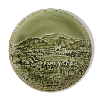 Old vintage plate in green earthenware landscape in relief