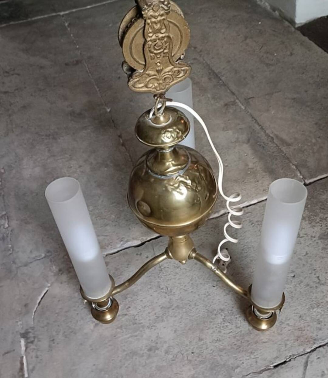 Brass chandelier with three flames.