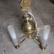Brass chandelier with three flames.