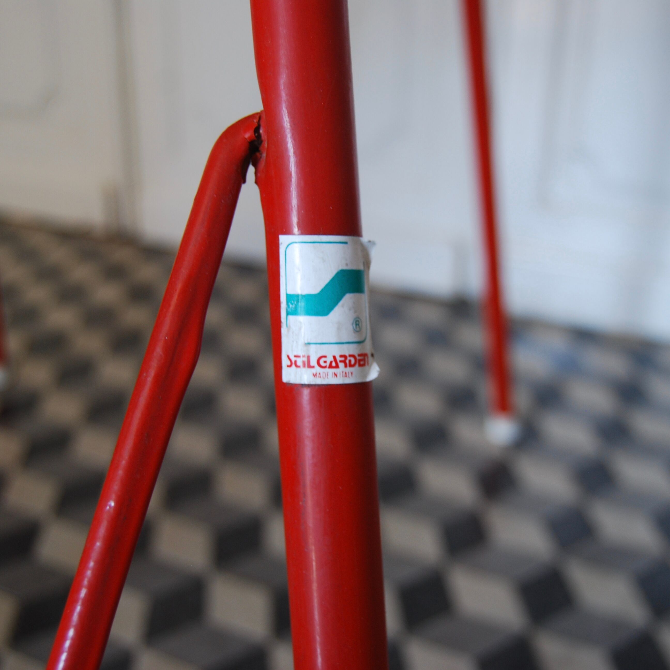 Red metal folding table Malaval type