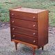 Vintage golden oak chest of drawers with 4 spindle feet from the 1950s