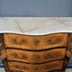 Louis XV style commode with rosewood veneer, gilded bronze mounts, and marble top.