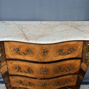 Louis XV style commode with rosewood veneer, gilded bronze mounts, and marble top.