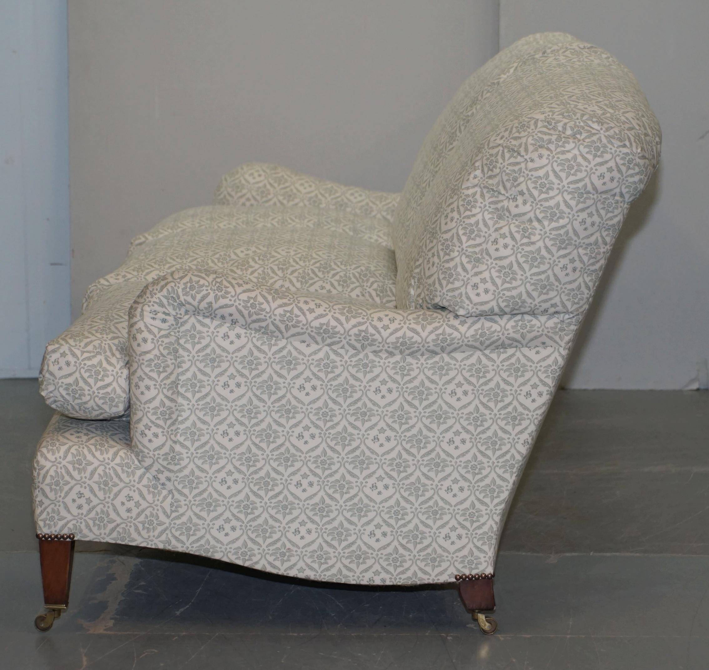 Howard & Sons canapé with feather cushions and ticking fabric, Victorian style.