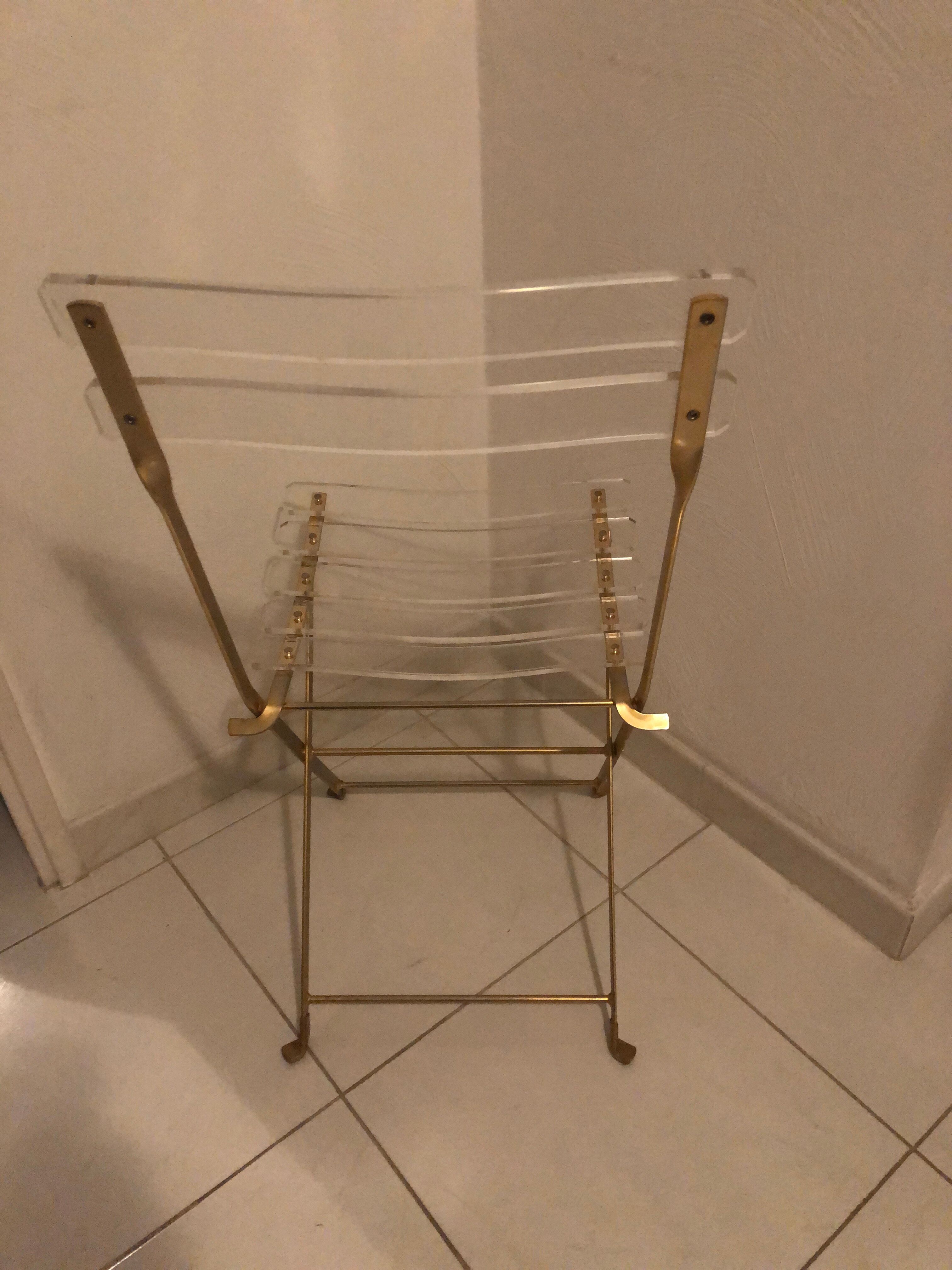 Folding chair in plexiglass and brass