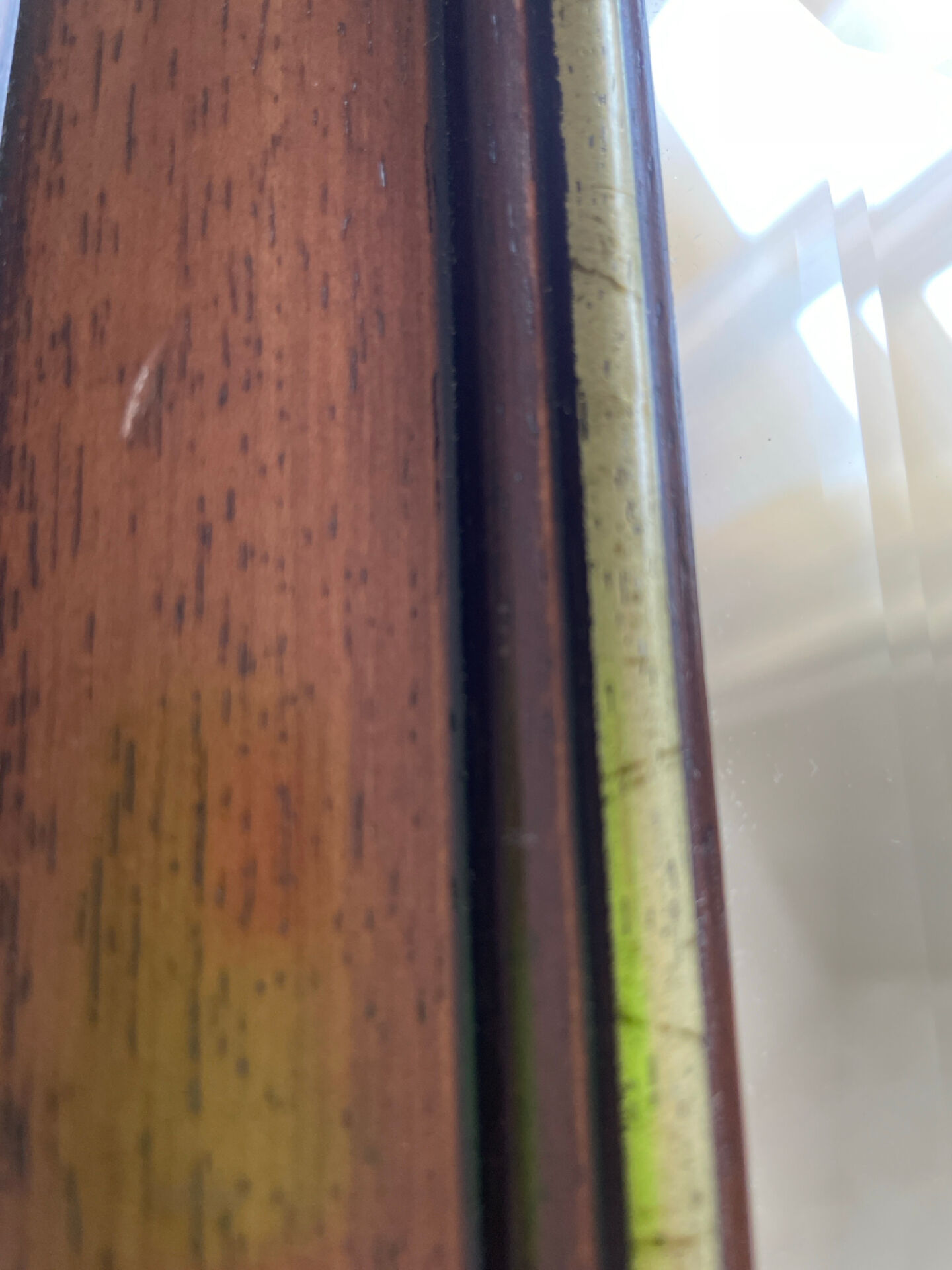 Vintage bevelled wall mirror in stained wood and brass