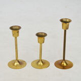 A set of three golden candlesticks, 1970s