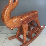 Decorative rocking elephant in carved exotic wood.
