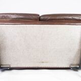 Two seater sofa upholstered with patinated brown leather and frame in metal, designed by Arne Norell