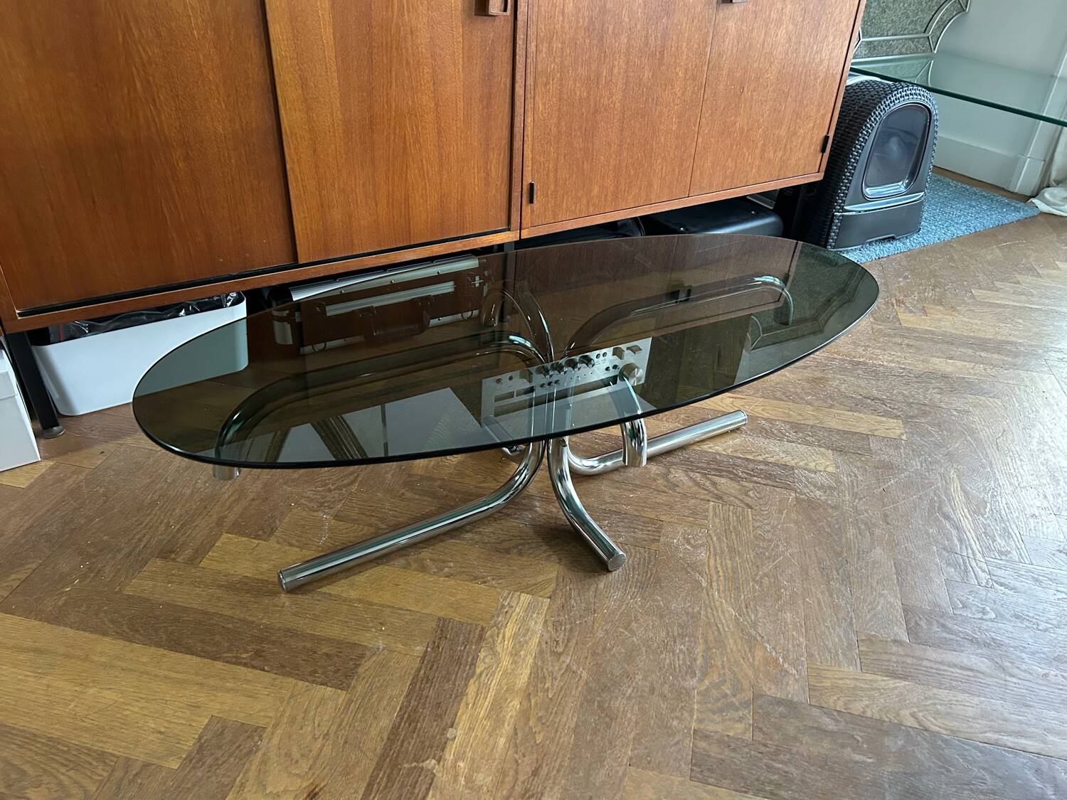 70s design oval coffee table in smoked black glass with chrome legs.