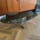 Table basse design ovale années 70 en verre fumé noir et pieds chromé