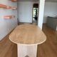 Oblong dining table in beige travertine.