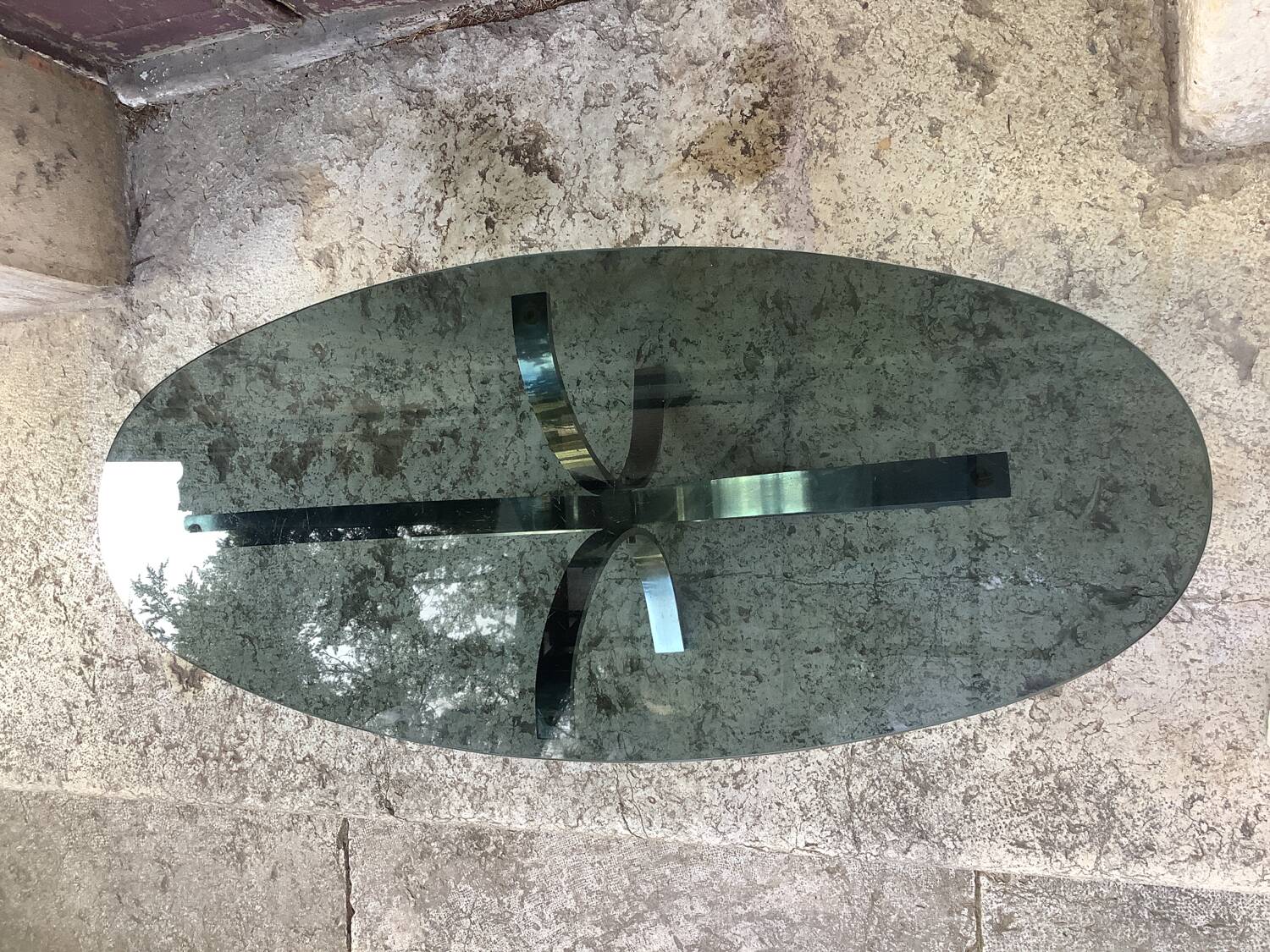 Oval smoked glass coffee table from the 70s