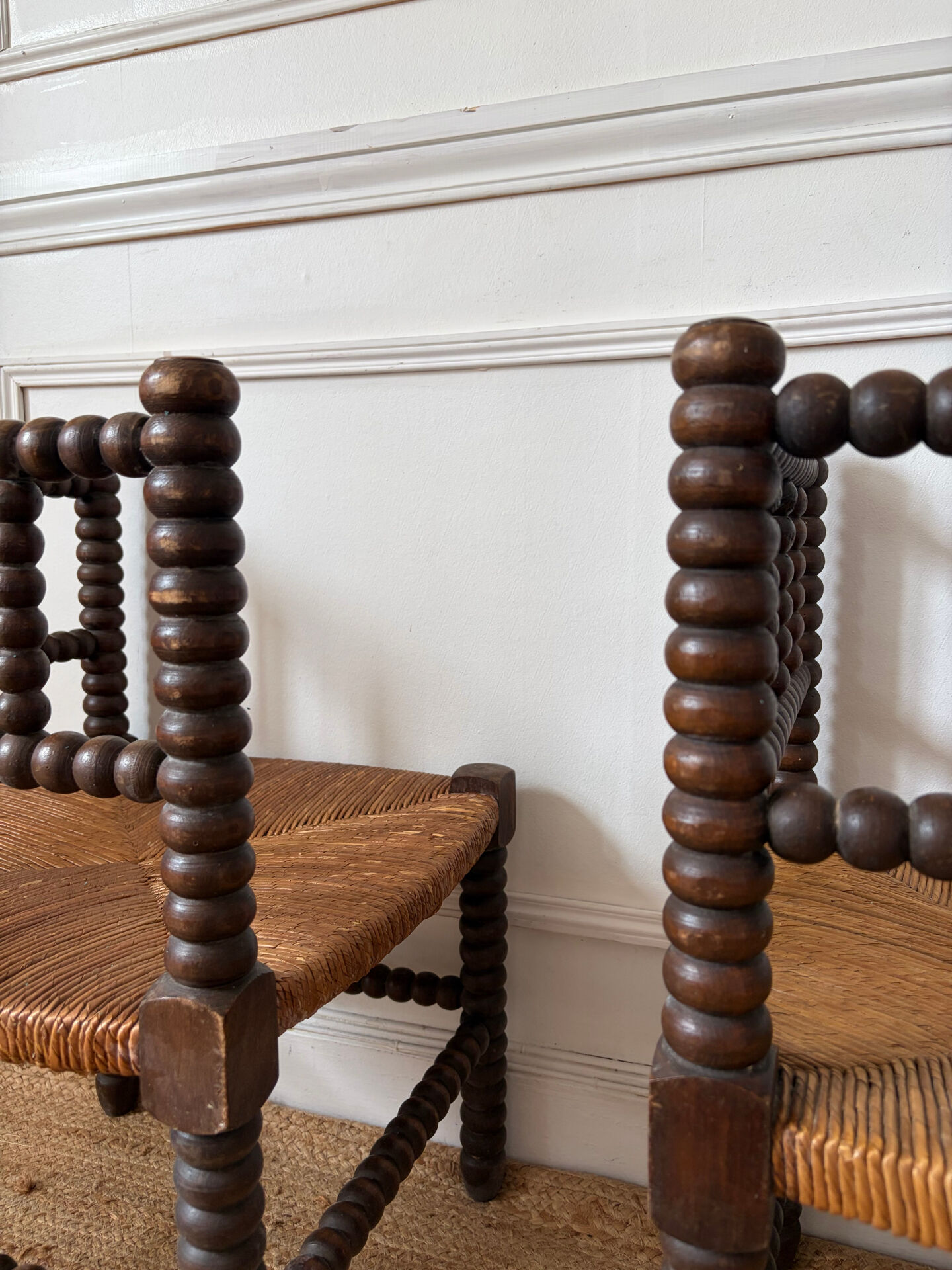 Pair of rush-seated chairs by the fireside "bobbin"