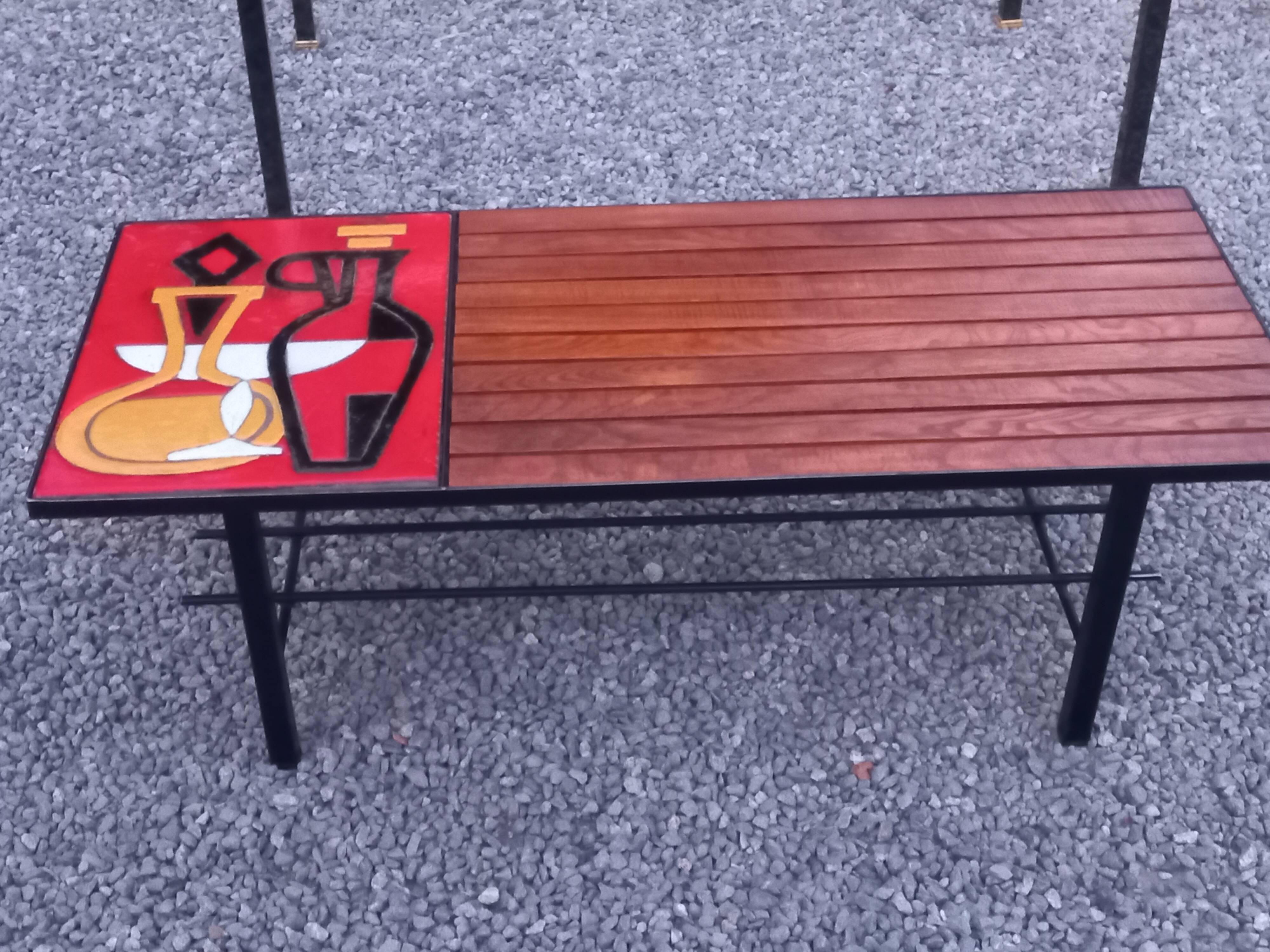 1970s design coffee table with ceramic and wood top, metal legs.