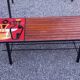 1970s design coffee table with ceramic and wood top, metal legs.