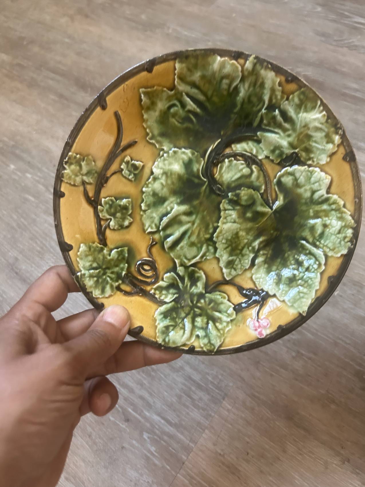 Four antique dessert plates in majolica with vine decoration.