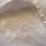 White tablecloth in fine embroidered white cotton.