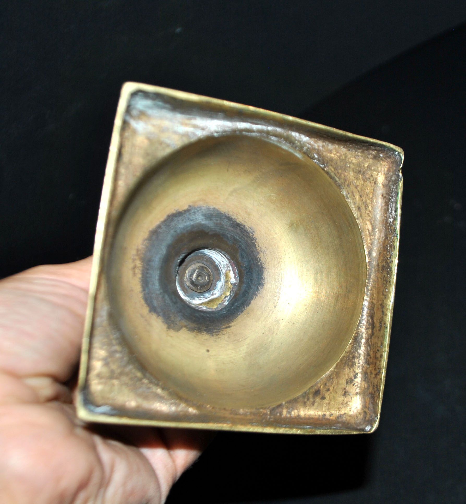 Antique baluster candlestick in bronze with hand-chiseled design.
