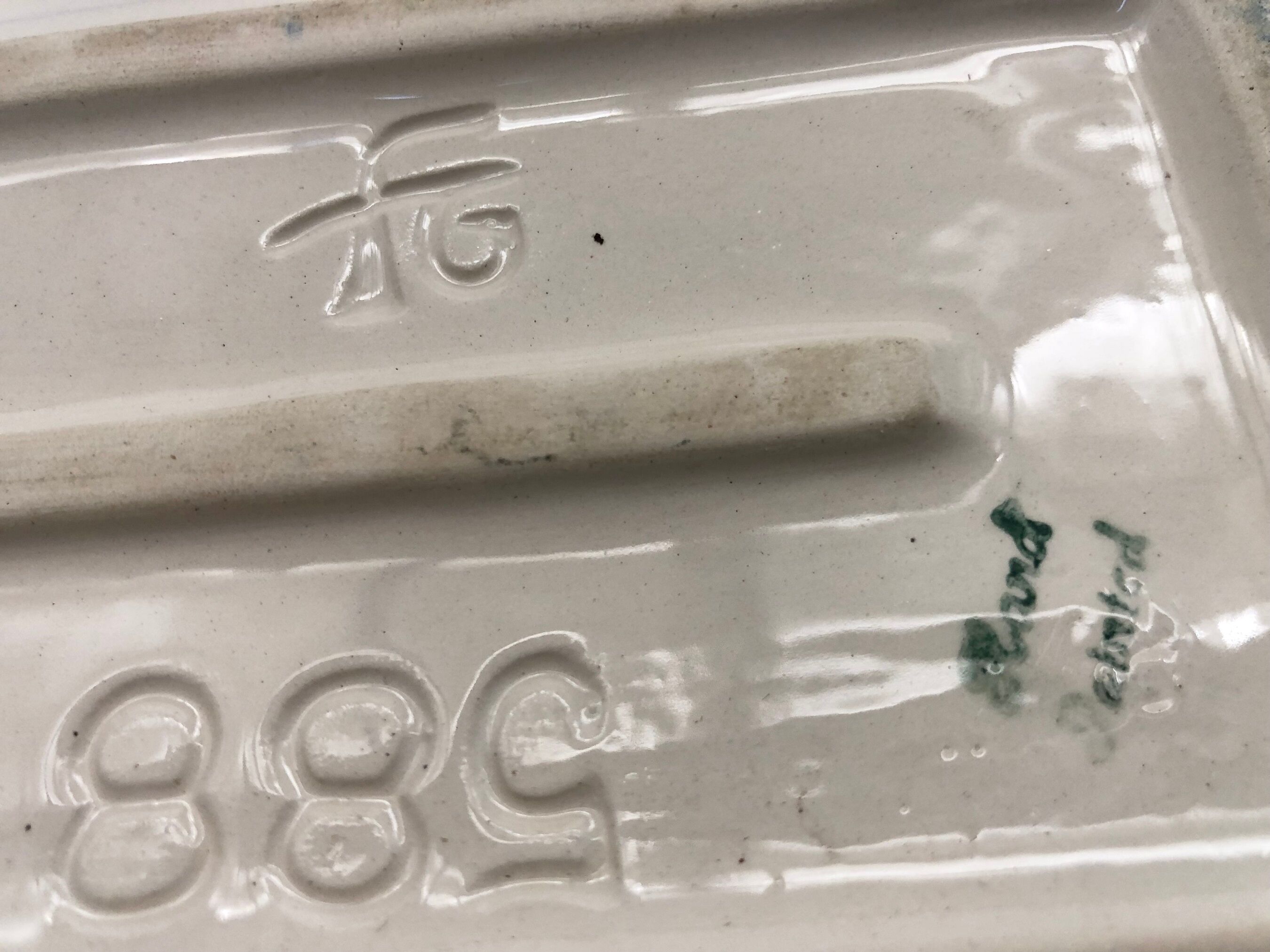 Slurry butter dish, with radish drawings. Signed "FG"