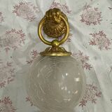 Vintage wall light in gilded bronze with a cracked glass globe.