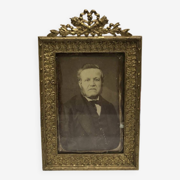Old photo portrait of a man with brass frame