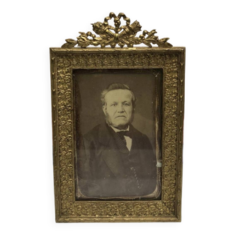 Old photo portrait of a man with brass frame