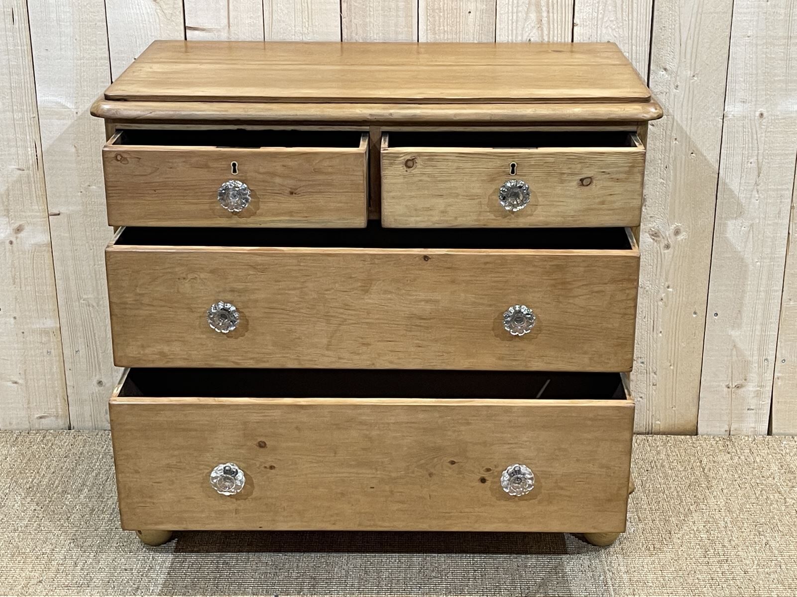 English chest of drawers in nineteenth century fir with its glass buttons