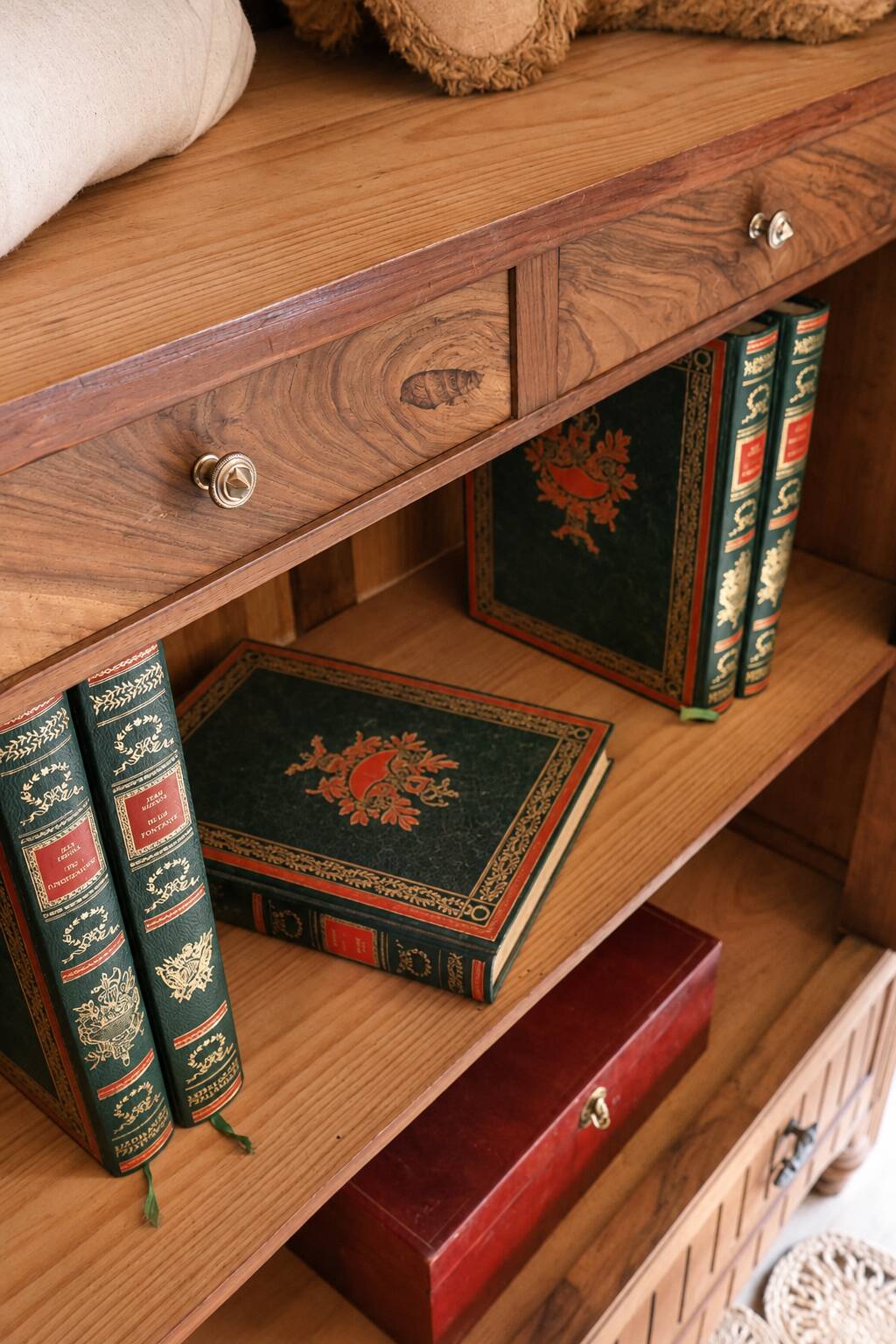 Antique walnut bonnetière with bevelled mirror.